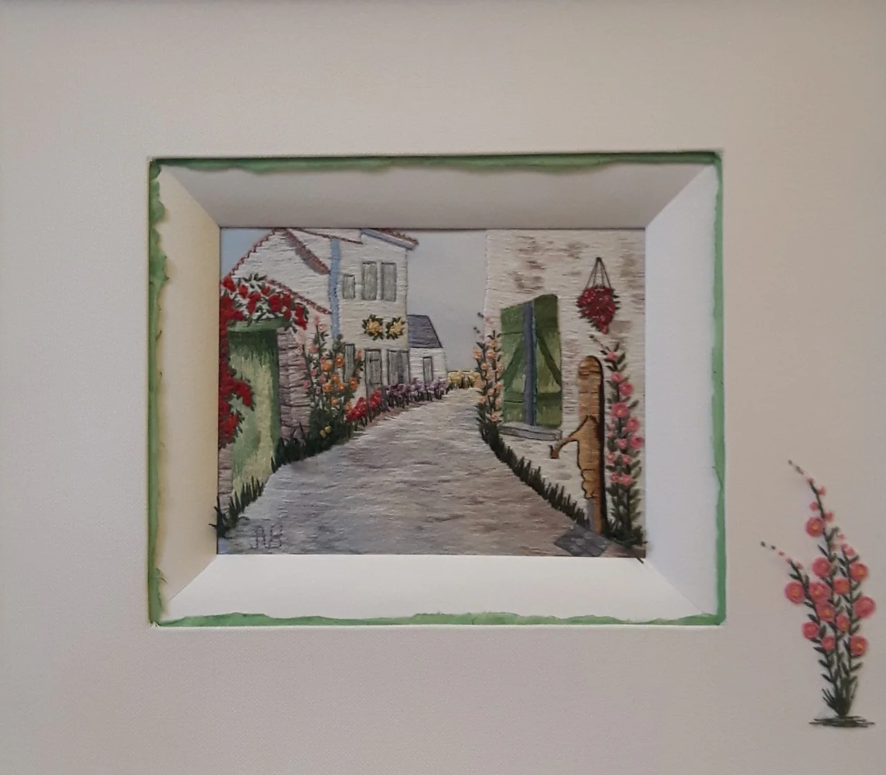 Ruelle de village brodée, dans un passe-partout clair.
