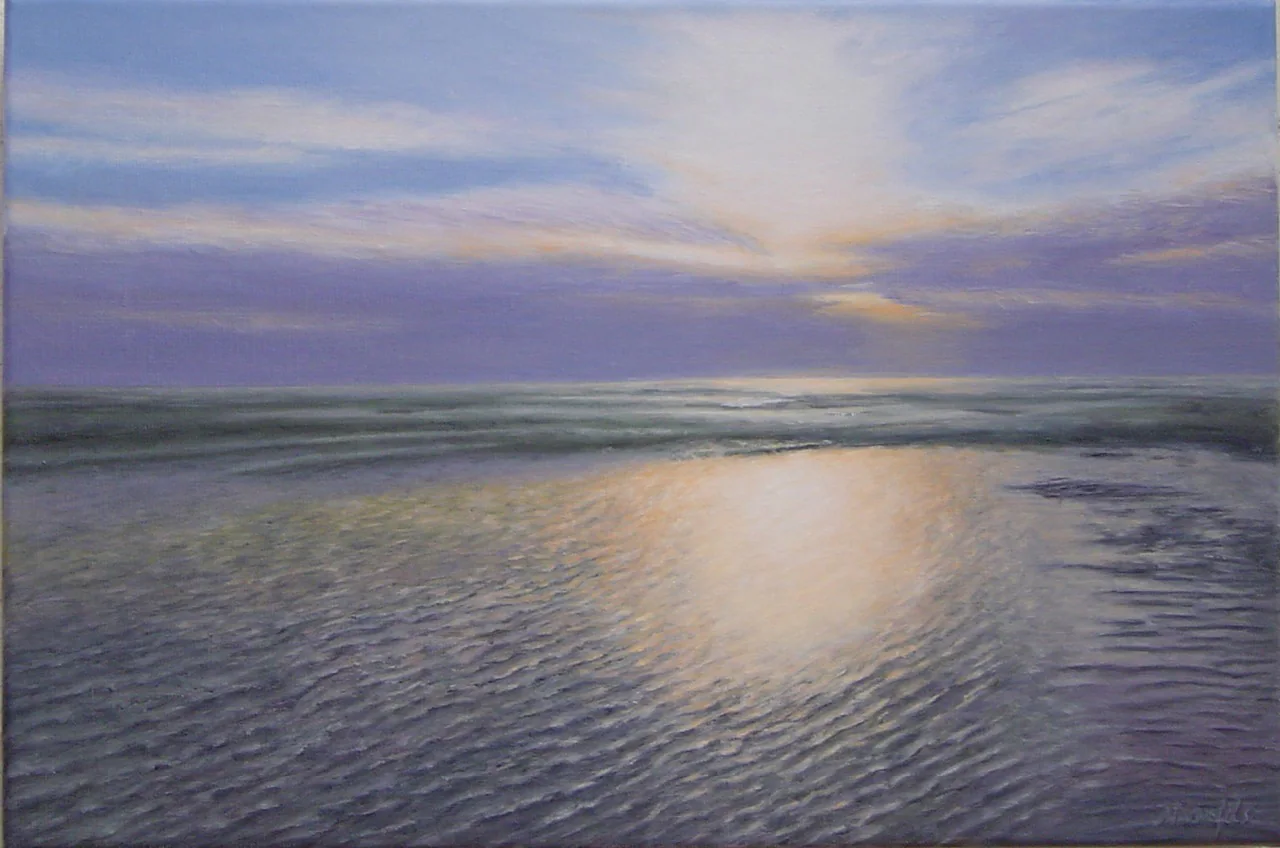 La lumière dorée du couchant sur la plage et la mer.
