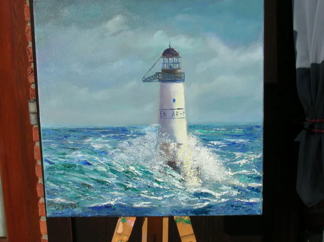 Un phare dans une mer agitée, toile posée sur un chevalet.